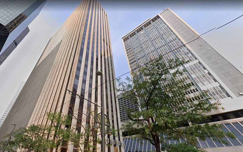 A view of two skyscrapers from the ground up.